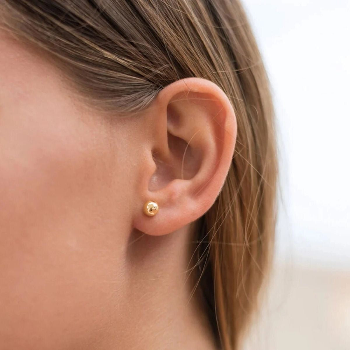 Gold stud earrings