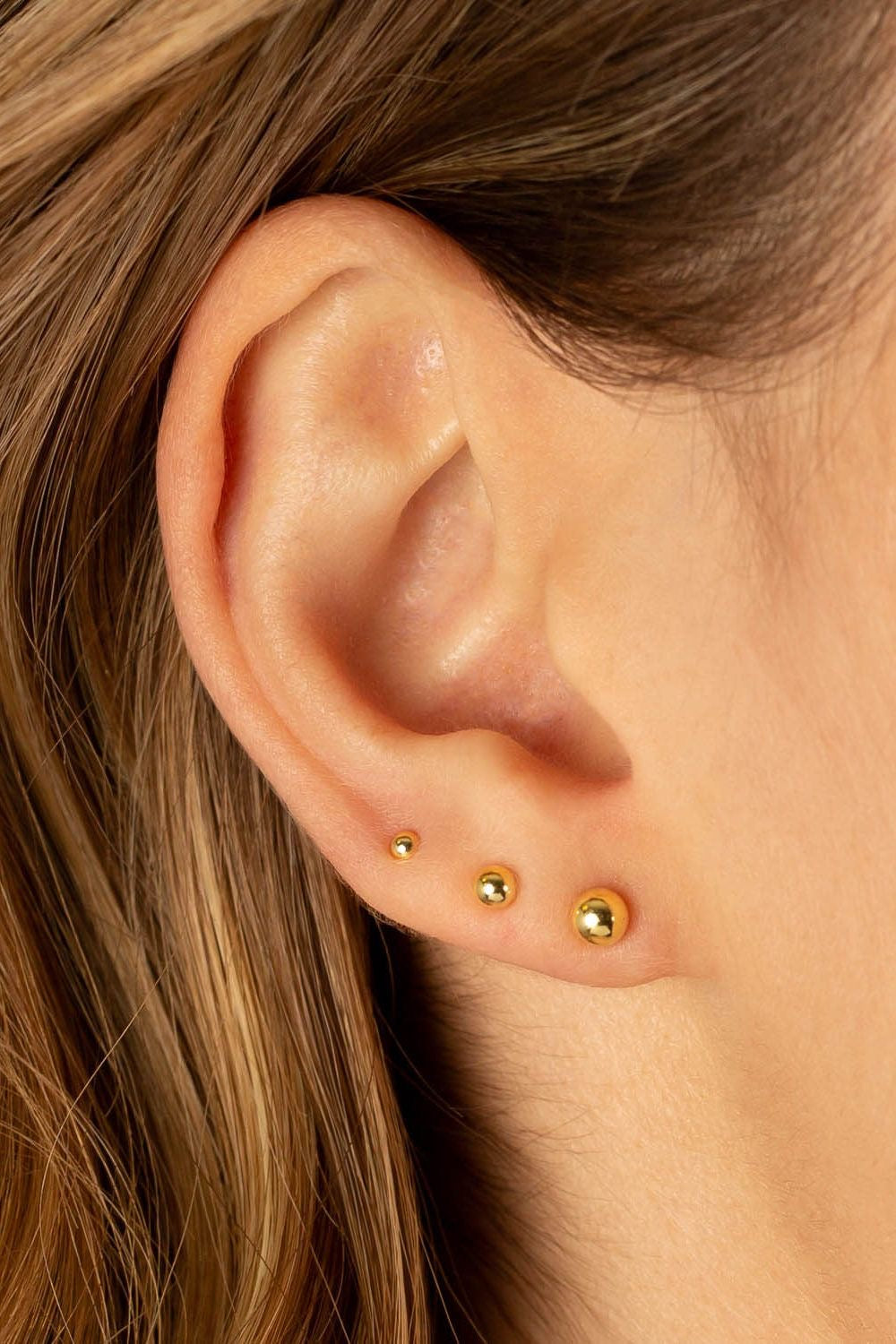 Gold stud earrings